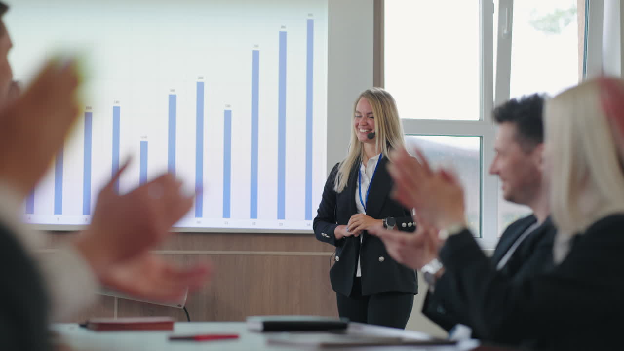 positive business coach woman is speaking in front top managers of big IT company lady with microphone