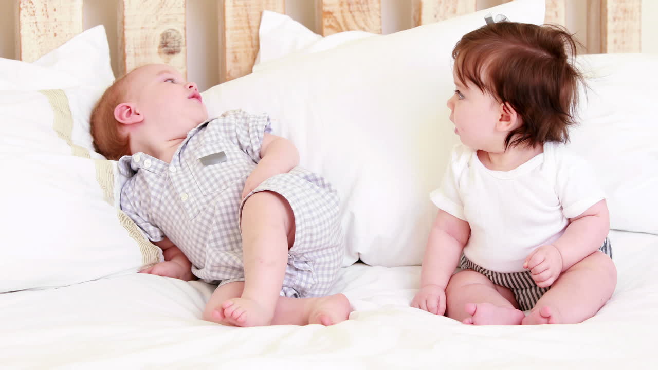 Cute babies on a bed