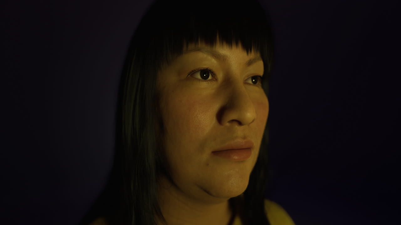 Portrait of an individual against a violet backdrop showcasing contemplation