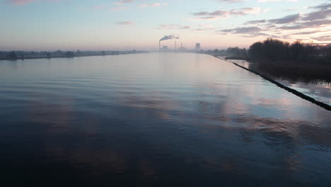 slow, dolly movement above the river with the beautiful sky reflecting on the water surface