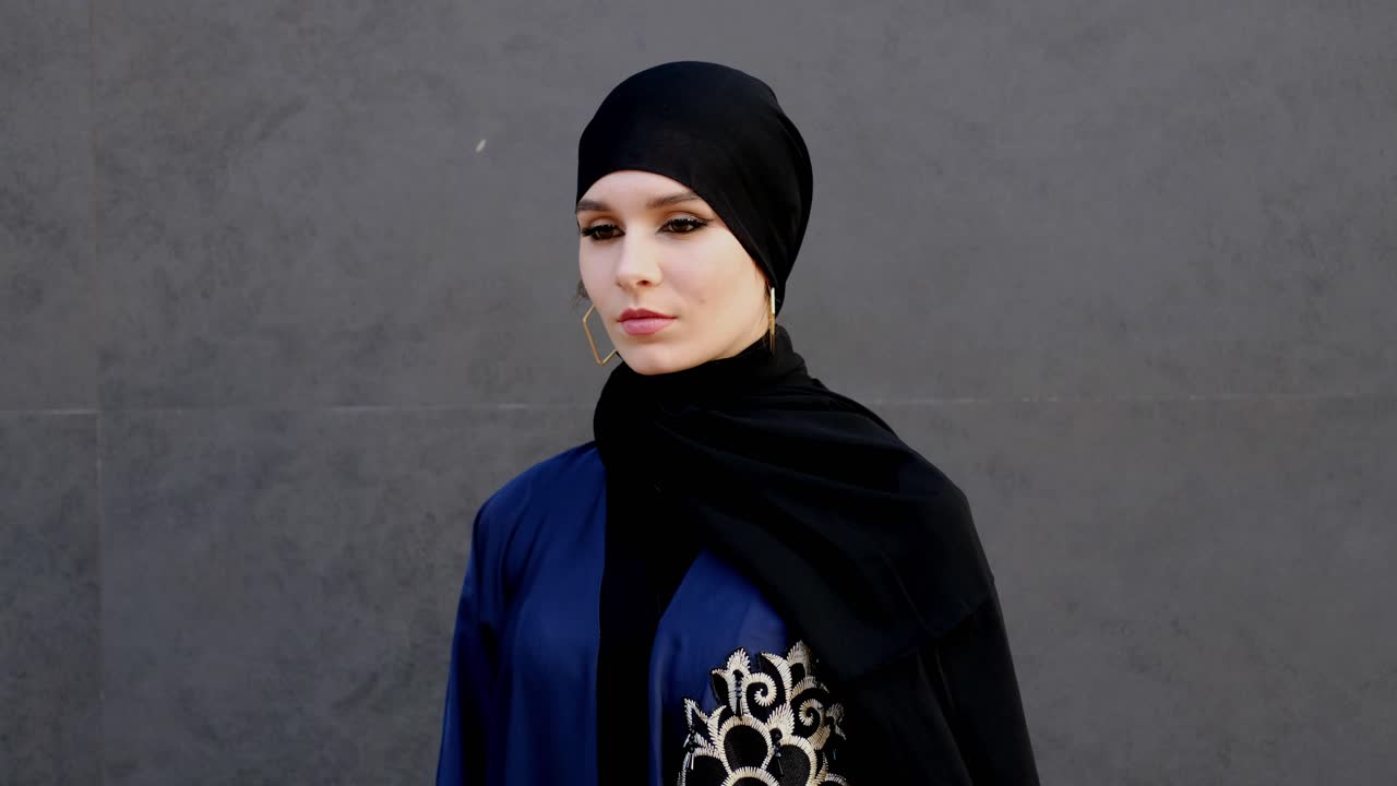 Face mask being worn by woman in Abaya and Hijab head scarf. Beautiful girl in traditional and cultural Emirati clothing in the Middle East.