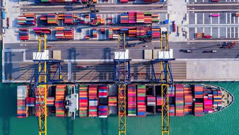 top view time lapse unloading goods from the ship in industrial port with container port where is a part of shipping