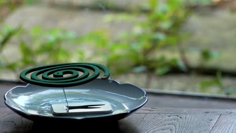 burning green mosquito coil in japanese house. summer season concept video.