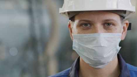 portrait of female factory worker in face mask