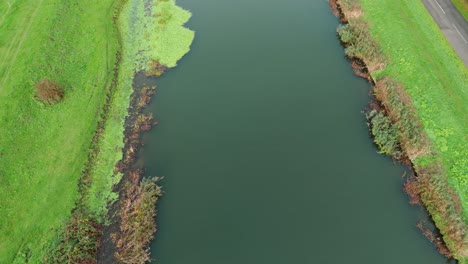 aerial view of canal with lush green banks