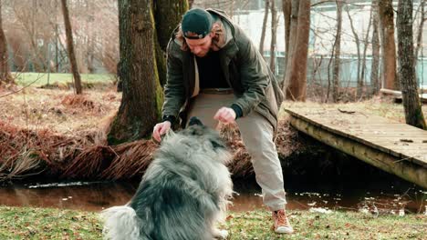 a not too successful attempt to practice a trick with his dog