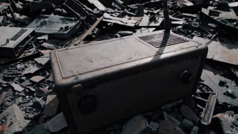 old radio in a pile of debris