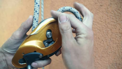 close up view of rope clipping to grigri equipment ready for climbing