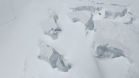 stunning aerial footage of glaciers in saas-fee and zermatt, showcasing ice formations, crevasses, seracs, and the dramatic impact of global warming on these majestic alpine landscapes.