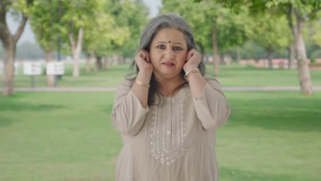 Guilty-Indian-old-woman-saying-sorry-and-apologizing-in-park