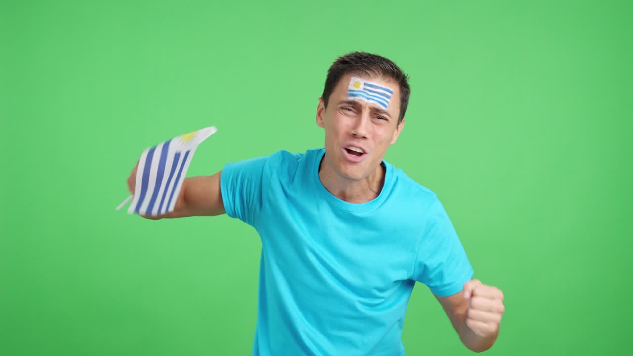 Man cheering for Uruguay during a match that is lost