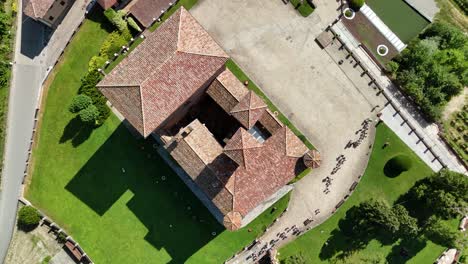grinzane cavour castle, unesco site, cuneo, piedmont, italy. 4k aerial view of the castle together with the vineyard. langhe-roero and monferrato. top down zenital circling ascending.