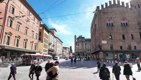 sunny day in bologna city center: street view with people and architecture