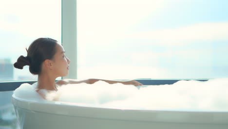 a young beautiful woman relaxes in a bubble bath