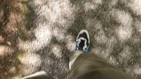 pov view of a man walks on a walking trail