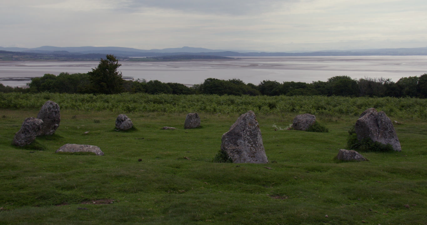 Slow zoom in to the Birkrigg stone circle with Morecambe Bay in background near Ulverston