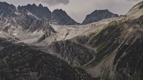 Rogers-Pass-BC-Canada-Aerial-v6-zoomed-drone-flyover-capturing-Glacier-National-Park's-rugged-terrain,-the-majestic-mountain-ranges,-towering-summits-and-peaks---Shot-with-Mavic-3-Pro-Cine---July-2023