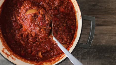 stirring-big-pot-of-bean-less-chili-top-view