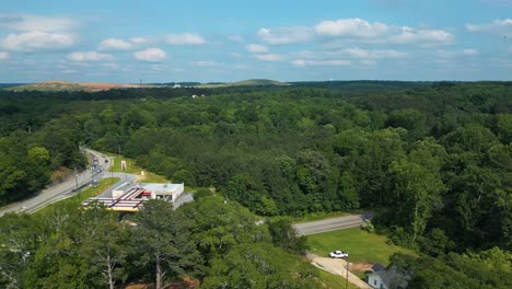 highways through lush green trees in the forest in summer. - aerial shot