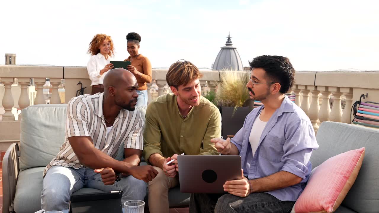 Diverse Group of Young Professionals Collaborating on a Rooftop Terrace