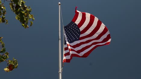 1080P-slow-motion-large-American-Flag-at-half-mast-waving-in-the-wind-for-shooting-victims-of-El-Paso-and-Dayton-Ohio-front-of-McDonald's