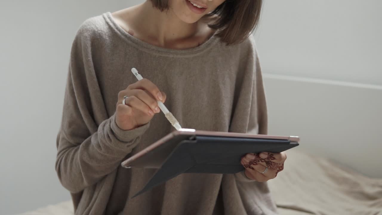 Woman using tablet with stylus