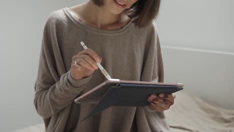 woman using tablet with stylus