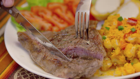 meat steak with corn tomatoes, lettuce and potatoes