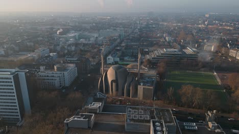 slow drone flight around a famous mosque made of monumental concrete in the center of cologne ehrenfeld on a winter day