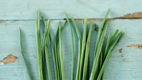 garlic chives on wooden table 4k