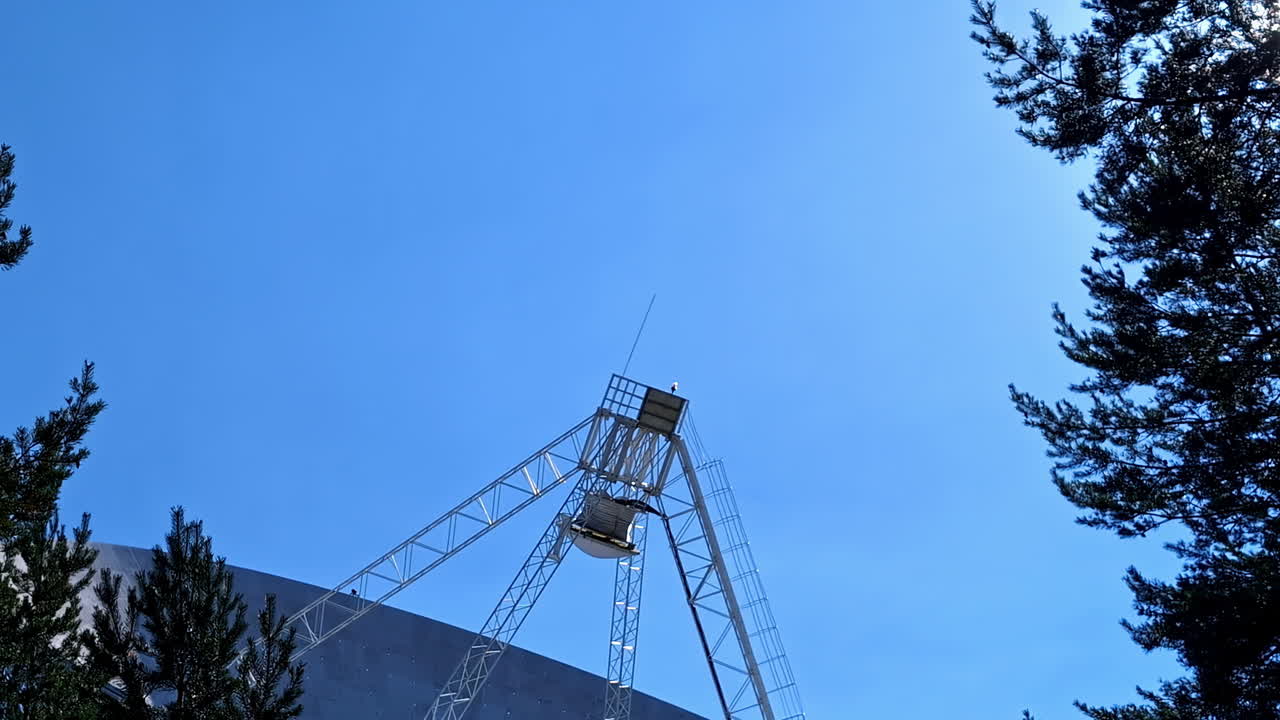 Large Radio Telescope Dish Antenna Against a Clear Blue Sky