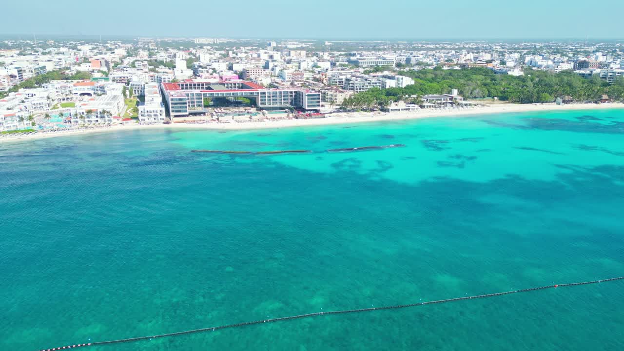 Aerial shot of clear turquoise water and beach in Playa del Carmen, Mexico