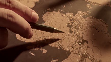 person pointing at a world map with a pen