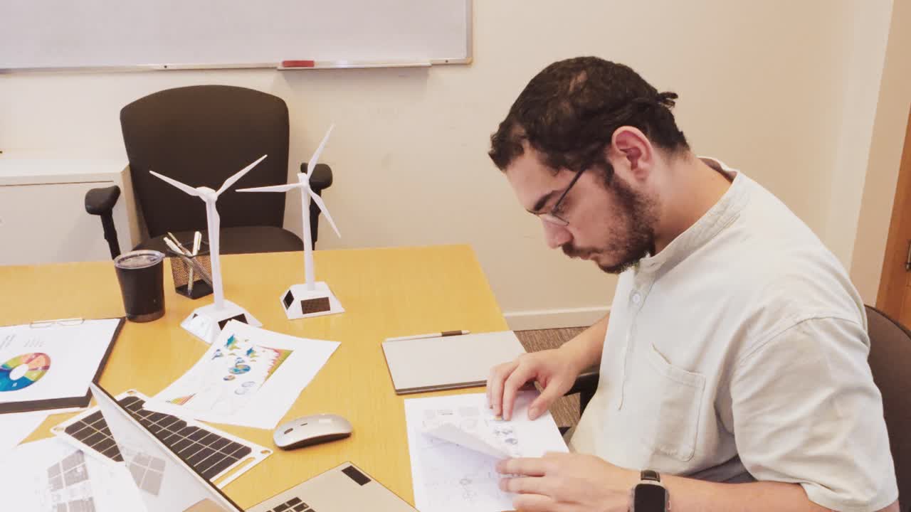 Man working on renewable energy project at desk