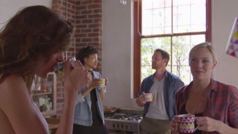 Five-happy-friends-laughing-in-kitchen,-close-up,-shot-on-R3D