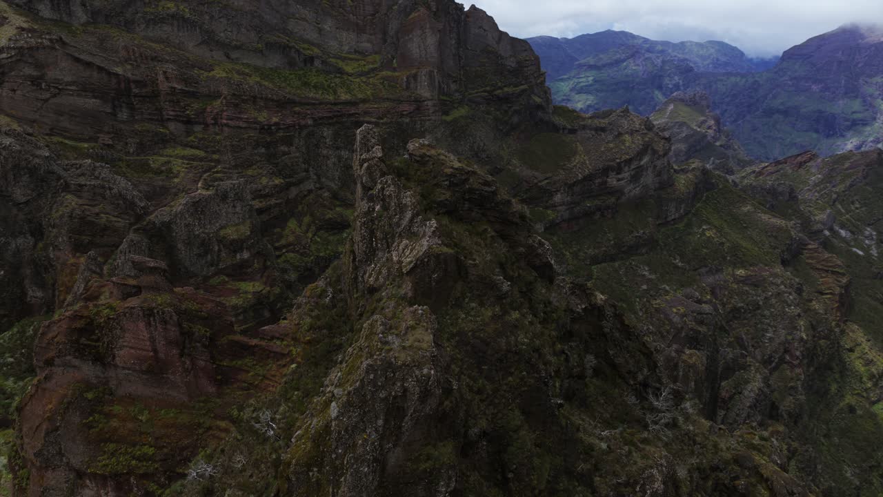 Aerial view of Pico do Areeiro, Madeira's third highest peak, rising above a rugged, rocky landscape
