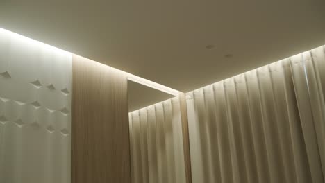 modern room interior with wood paneling and curtains
