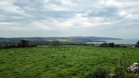 scenic welsh green countryside farmland meadows and coastal bay rural landscape scene