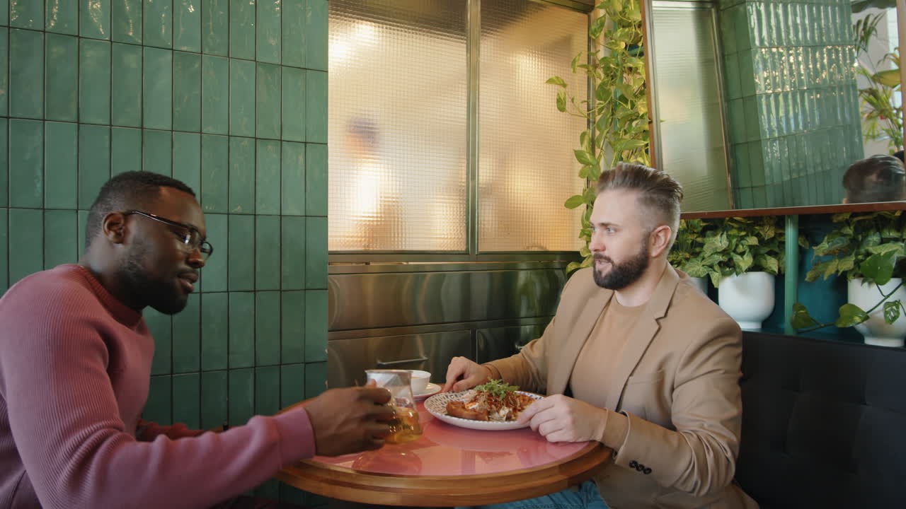 Multiethnic Colleagues Meeting on Business Lunch in Cafe