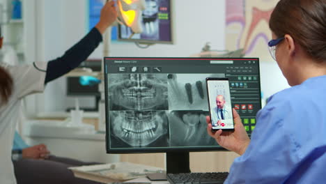 nurse having video call with expert stomatologic medic