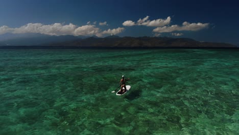 Drone-flying-above-a-pretty-lady-in-bikini-on-a-paddle-board