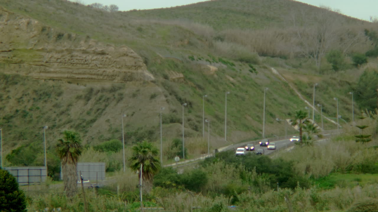 Some cars driving down to Costa da Caparica.