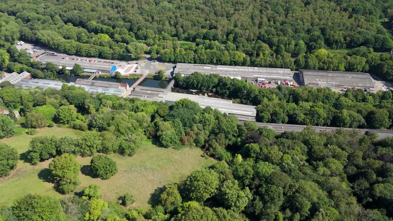 Drone footage of industrial heritage car factory museum set in scenic countryside valley Ambergate Derbyshire England sunny day