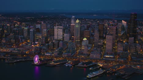 above seattle skyline aerial night skyscraper office buildings pier ferry terminal