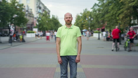man standing on city street