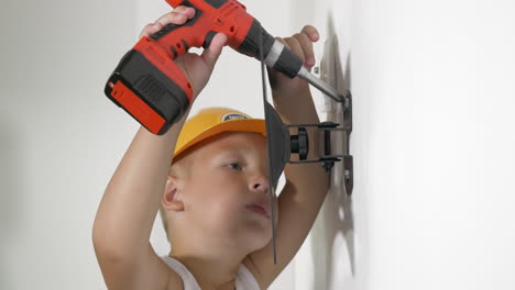 niño trabajando con un destornillador eléctrico