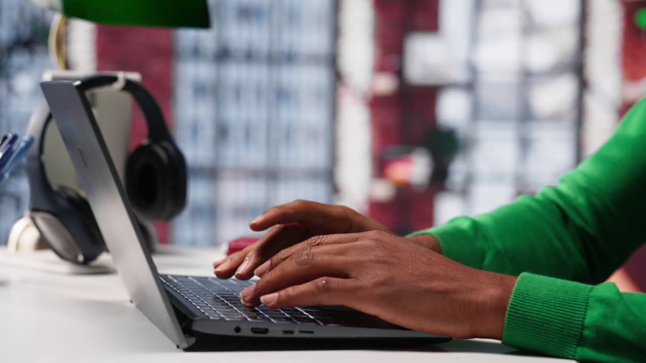 African american teleworker typing ideas to create a vision board on laptop