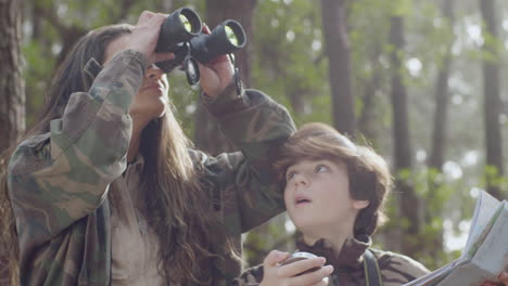 Caucasian-mother-and-son-exploring-wildlife-and-birdwatching-in-a-natural-park