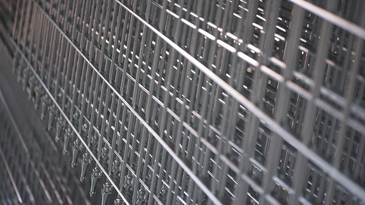 Galvanized Metal Fence hanging during production process. Close-up Rack focus.