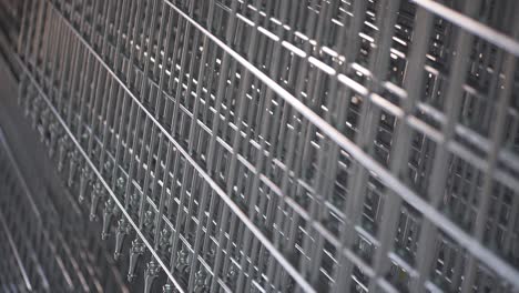 galvanized metal fence hanging during production process. close-up rack focus.
